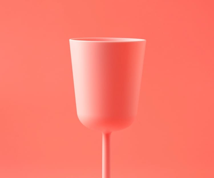 Picture of a cup against a pink background.